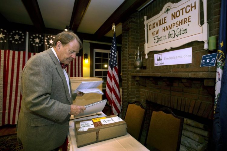 Town moderator Tom Tillotson arrives with ballots as voters get ready to cast their votes just after midnight in Dixville Notch, N.H., in November 2016. 