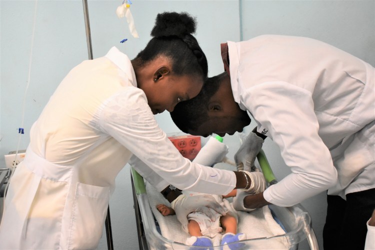In 2019, residents draw blood from an infant at Justinien University Hospital, the second-largest teaching hospital in Haiti. Konbit Sante formed their first partnership with the hospital in 2001.