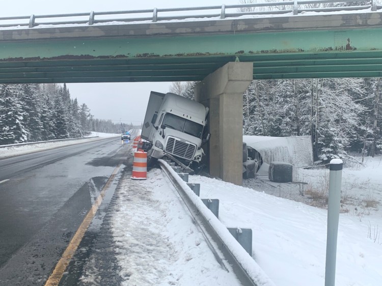 State police say this truck slid along about 100 yards of guardrail before hitting the bridge support on Interstate 95 in Aroostook County on Saturday.