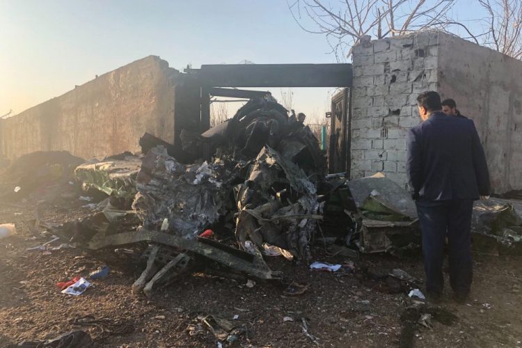 Debris from a plane crash is seen on the outskirts of Tehran, Iran, on Wednesday. A Ukrainian airplane carrying at least 170 people crashed shortly after takeoff from Tehran’s main airport, killing all on board, state TV reported.