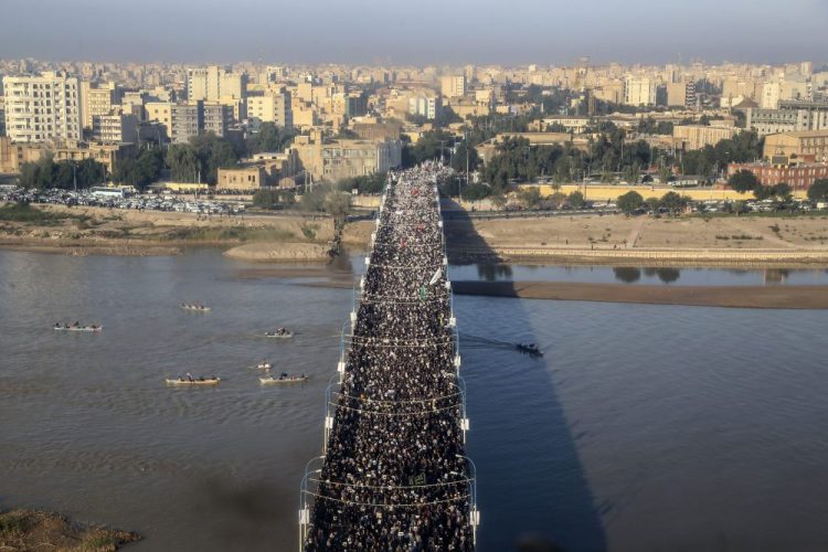 An aerial view shows mourners attending a funeral ceremony for Gen. Qassem Soleimani and his comrades, who were killed in Iraq in a U.S. drone strike, in the southwestern city of Ahvaz, Iran on Sunday. The body of Gen. Qassem Soleimani arrived Sunday in Iran to throngs of mourners, as President Trump threatened to bomb 52 sites in the Islamic Republic if Tehran retaliates by attacking Americans.