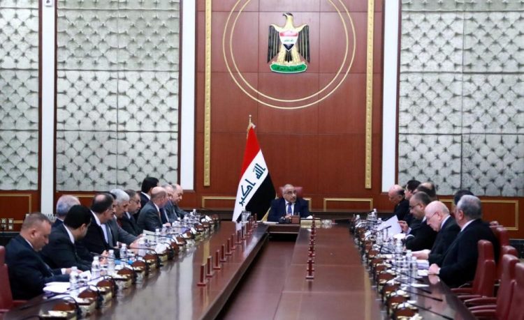 Iraqi acting Prime Minister Adil Abdul-Mahdi, center, heads a Cabinet meeting at the prime minister's office, in Baghdad, Iraq, on Tuesday. Abdul-Mahdi said the United States must withdraw its troops from Iraq.