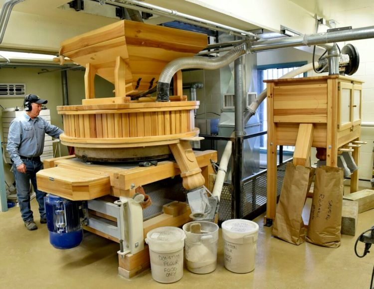 A huge millstone is used to grind flour inside the Grist Mill in Skowhegan last year. One of its associated businesses, Maine Grains, won two Good Food Awards at the San Francisco competition.