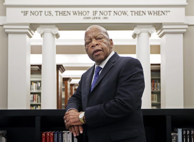 Rep. John Lewis, D-Ga., poses for a photograph in 2016 under a quote of his that is displayed in the Civil Rights Room in the Nashville Public Library in Nashville, Tenn. 