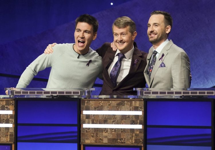 Contestants, from left, James Holzhauer, Ken Jennings and Brad Rutter appear on the set of "Jeopardy! The Greatest of All Time," in Los Angeles. The all-time top “Jeopardy!” money winners; Rutter, Jennings and  Holzhauer, will compete in a rare prime-time edition of the TV quiz show, which will air on consecutive nights beginning 8 p.m. Tuesday.