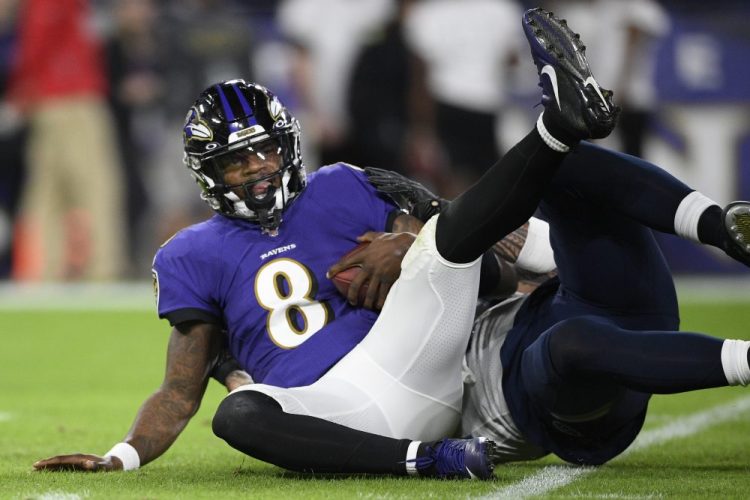 Baltimore quarterback Lamar Jackson is sacked by Tennessee outside linebacker Kamalei Correa during the Titans' 28-12 win in the AFC divisional playoffs on Saturday in Baltimore.