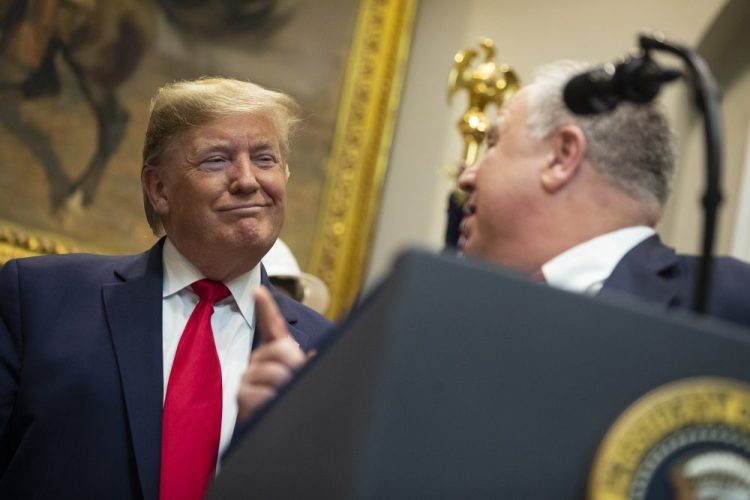 President Trump listens as Secretary of the Interior David Bernhardt speaks on proposed changes to the National Environmental Policy Act, Thursday at the White House in Washington.