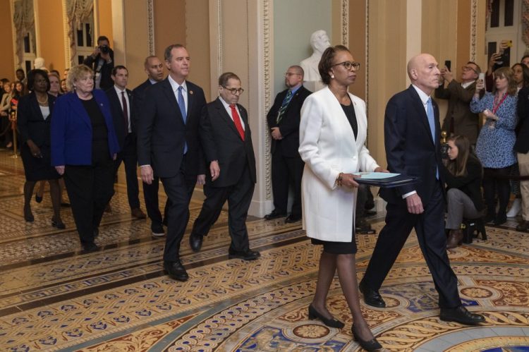 House Sergeant at Arms Paul Irving and Clerk of the House Cheryl Johnson carry the articles of impeachment against President Trump to Secretary of the Senate Julie Adams on Wednesday. Following are impeachment managers, House Judiciary Committee Chairman, Rep. Jerrold Nadler, D-N.Y., House Intelligence Committee Chairman Adam Schiff, D-Calif., Rep. Hakeem Jeffries, D-N.Y., Rep. Sylvia Garcia, D-Texas, Rep. Val Demings, D-Fla., Rep. Zoe Lofgren, D-Calif., and Rep. Jason Crow, D-Colo. 