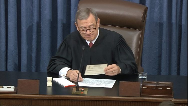 In this image from video, presiding officer Chief Justice of the United States John Roberts reads a question Wednesday during the impeachment trial against President Trump in the Senate at the U.S. Capitol in Washington.