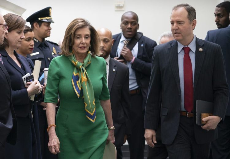 Speaker of the House Nancy Pelosi, D-Calif., joined by House Intelligence Committee Chairman Adam Schiff, D-Calif., leaves a lengthy closed-door meeting with the Democratic Caucus at the Capitol in Washington on Tuesday.