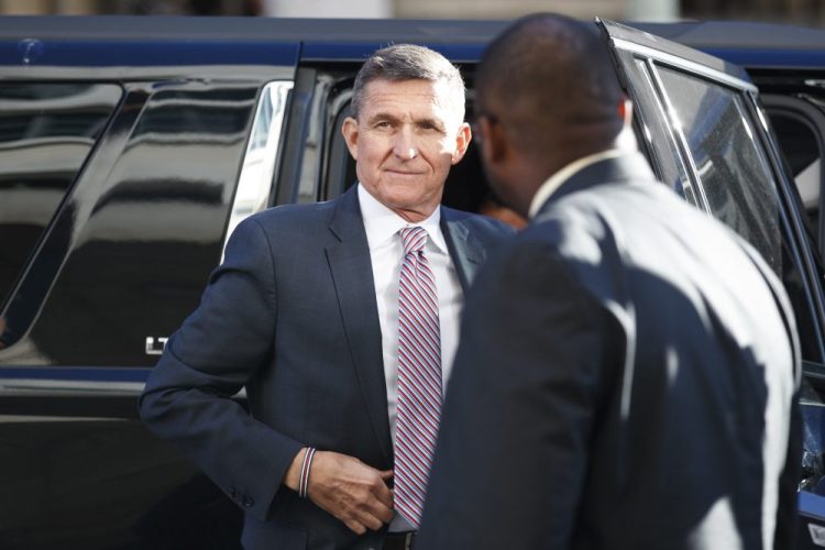President Trump's former national security adviser Michael Flynn arrives at federal court in Washington in 2018. The Justice Department now says the former Army lieutenant general no longer deserves credit for helping the government.