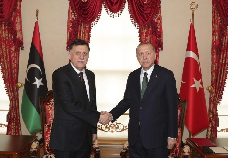 Turkey's President Recep Tayyip Erdogan, right, shakes hands with Fayez al Sarraj, the head of Libya's internationally-recognized government, prior to their meeting in Istanbul on Sunday. The meeting at Dolmabahce Palace took place on the first day of a ceasefire in Libya initiated by Turkey and Russia. 