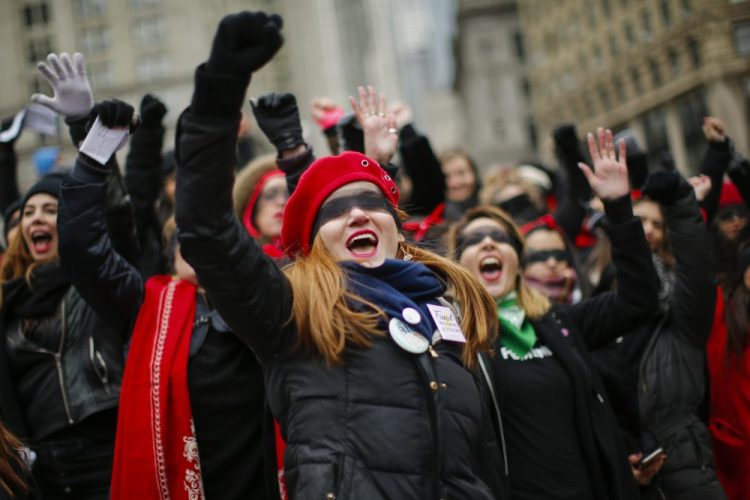 Women take part in a rally before the Women's March on Saturday in New York. Several thousand came out for the protest in Washington, but it was far fewer than last year, when about 100,000 people held a rally east of the White House.