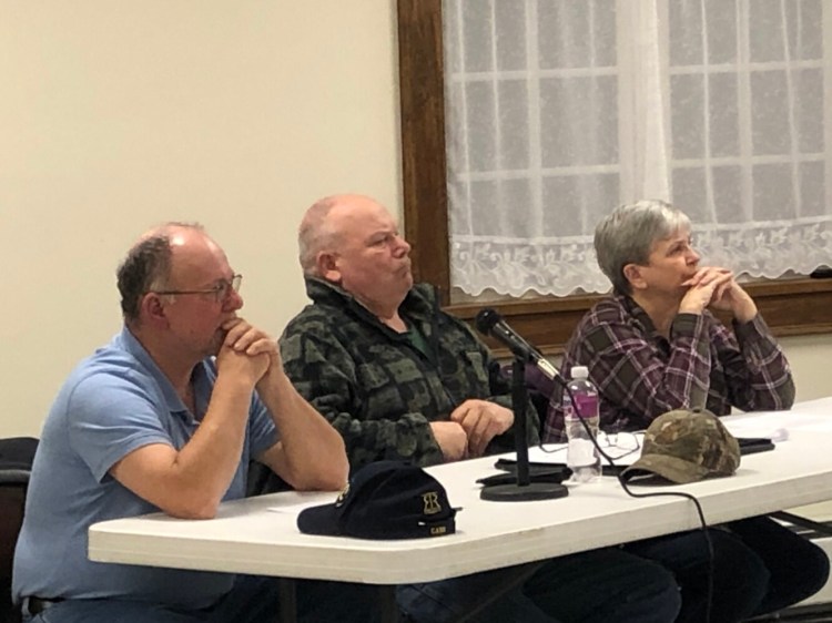 The Dresden Board of Selectmen, from left, Allan Moeller Sr., Gerald Lilly and Trudy Foss, listen to residents Wednesday at a special town meeting where residents voted whether or not to buy the property next to the Town Office. 