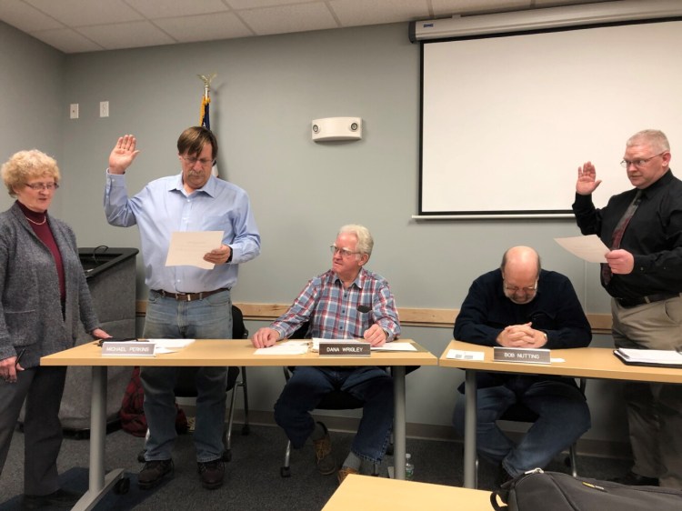 Deputy Town Manager Jan Porter, left, swears in reelected Councilor Mike Perkins, left, and first-time Councilor Dave Groder during the first Town Council meeting of the year Wednesday. 