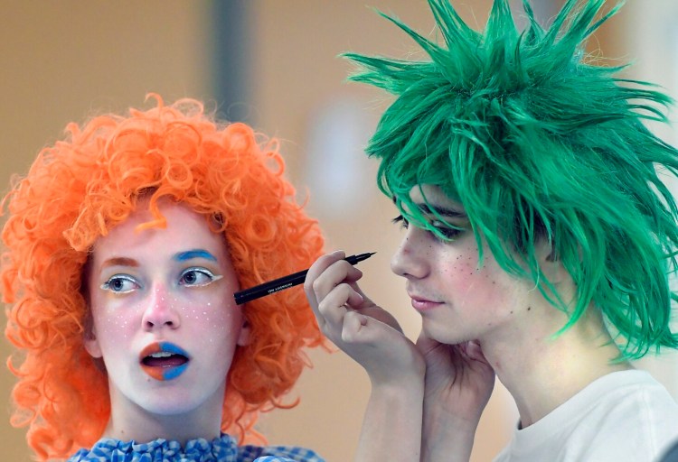Gardiner Area High School student Kayla Bailey applies makeup Tuesday to Taylor Sutherburg to perform as munchkins during a dress rehearsal of the Broadway musical "The Wiz" in the school's theater. Performances of the 1970s-era remake of the "Wizard of Oz" will take place at 7 p.m. Feb. 7-8 in the Gardiner Area High School Little Theater.