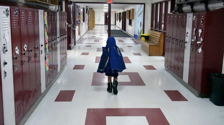 A child walks toward the entrance and lobby at Richmond High School on Wednesday. Residents of the community are considering leaving Regional School Unit 2. 