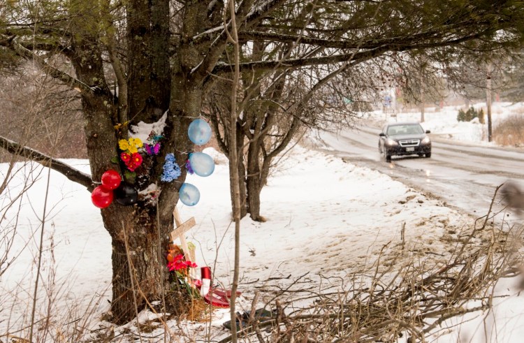 Mourners have left a cross and other items around a large pine tree on Hinckley Road in Clinton, where three youths died Sunday morning in a one-car accident.