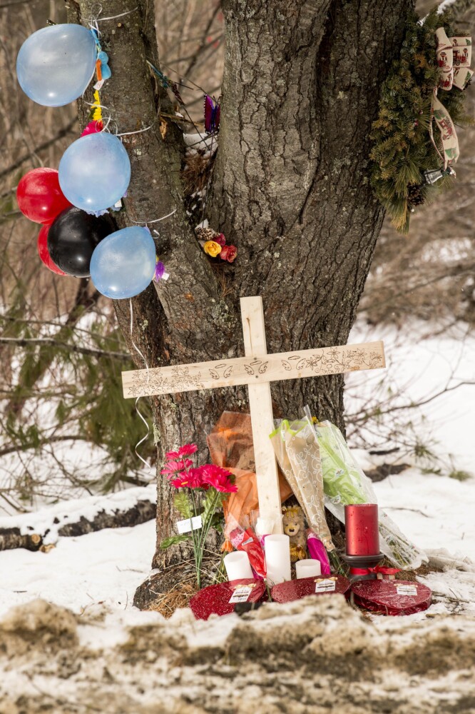Mourners have left a cross and other items around a large pine tree on Hinckley Road in Clinton, where three youths were killed Sunday morning in a one-car accident.