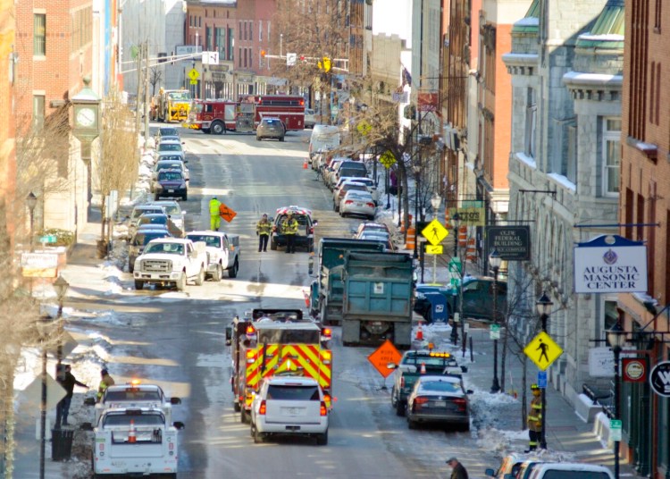 Augusta Fire Department and Summit Natural Gas work Friday at the scene of a gas leak at the corner of Water and Winthrop streets. The road was shut down as officials worked to repair the leak. 