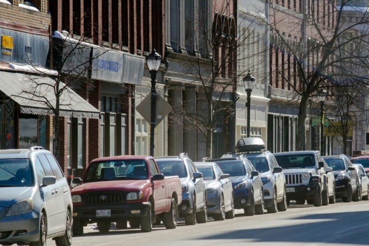 Cars are parked along Water Street in downtown Augusta on Friday. A new study of downtown parking recommends that Water Street parking be charged by the hour. 