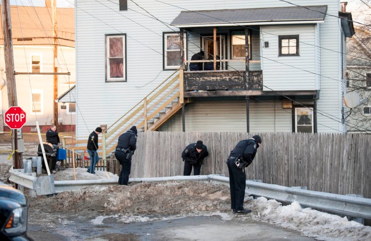 Officers from the Waterville Police Department and Maine State Police search outside the apartment building at 42 Summer St. in Waterville, where Emahleeah Frost, 7, was injured Feb. 28 in a drive-by shooting.
