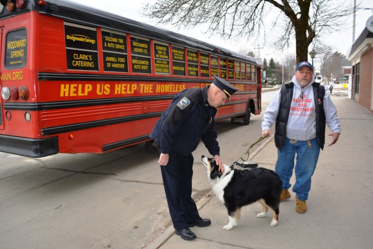 Pittsfield Police Chief Pete Bickmore, left, greets Koji, the Soupman's support dog, and Peter Kelleher, the Soupman. Kelleher stopped in Pittsfield on Feb. 5 to drop off 170 homeless survival packs for the needy in the area.
