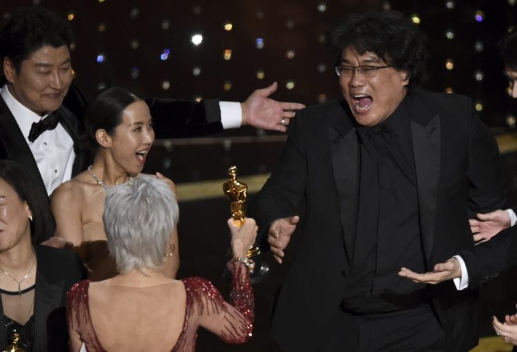 Bong Joon Ho, right, reacts as he is presented with the award for best picture for "Parasite" from presenter Jane Fonda at the Oscars on Sunday.