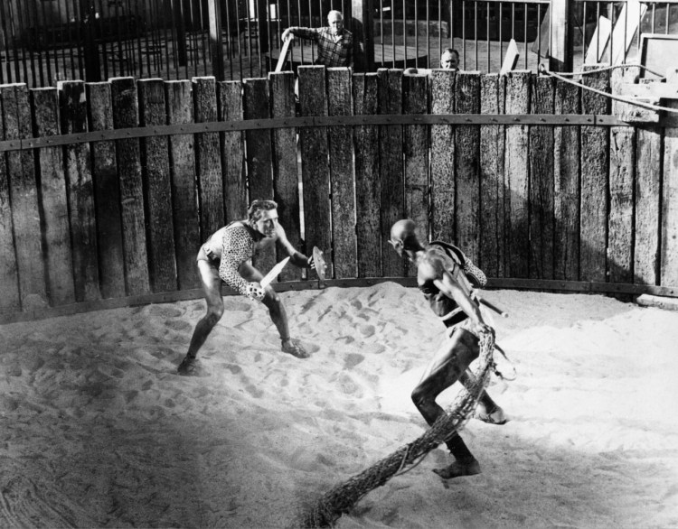 Kirk Douglas, left, in the title role as a Roman slave and gladiator, Spartacus, battles Woody Strode in the role of gladiator Draba in a scene from "Spartacus" filmed in Hollywood in 1959. 