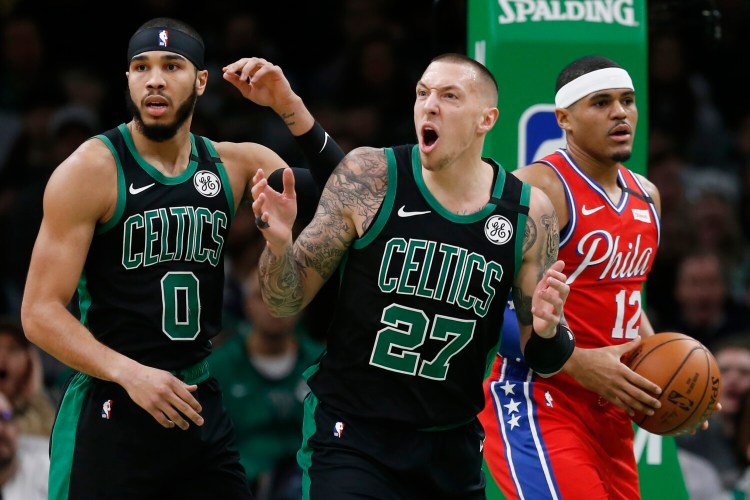 Boston's Daniel Theis reacts beside teammate Jayson Tatum and Philadelphia's Tobias Harris during the Celtics' 116-95 win Saturday in Boston.