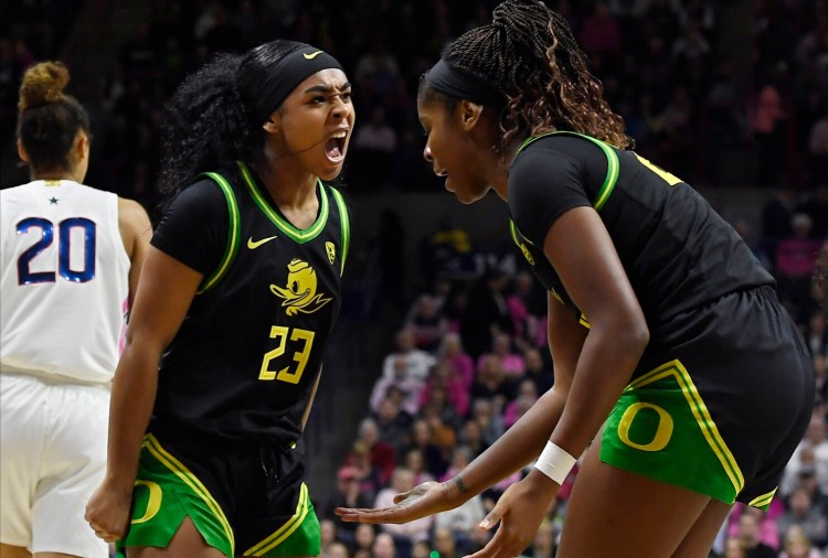 Oregon's Minyon Moore celebrates with teammate Oregon's Ruthy Hebard during the Ducks' 74-56 win over UConn on Monday in Storrs, Connecticut.