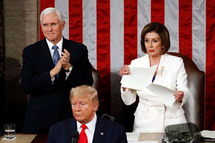House Speaker Nancy Pelosi tears her copy of President Trump's State of the Union speech after he delivered it to a joint session of Congress on Tuesday night. Vice President Pence is at left.