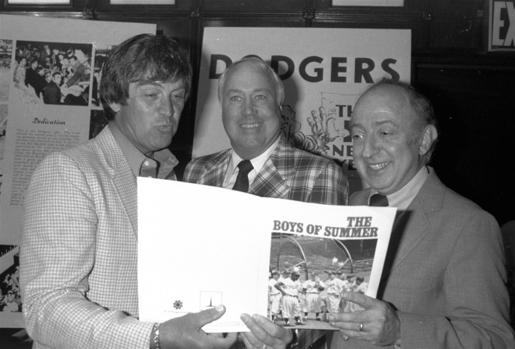 In this June 24, 1982, file photo, author Roger Kahn, right, joins former Brooklyn Dodger outfielder Duke Snider, center, and former Dodger pitcher, Clem Labine, at the start of production on the television film based on Kahn's best selling book, "The Boys of Summer," in New York. Kahn, the writer who wove memoir and baseball and touched millions of readers through his romantic account of the Brooklyn Dodgers died Thursday at a nursing facility in Mamaroneck, N.Y., according to his son Gordon Kahn. He was 92.
