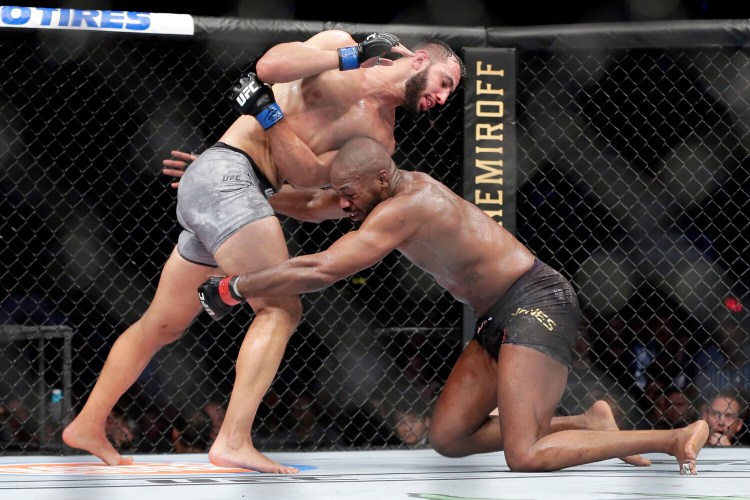 Jon Jones, right, goes for a take down of Dominick Reyes during their UFC light heavyweight fight on Saturday in Houston. Jones won in a unanimous decision in a fight many feel he lost. 