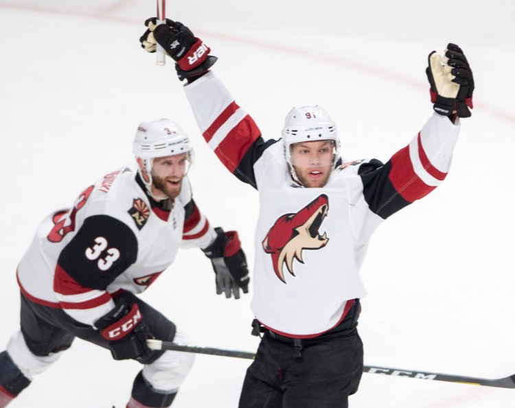 Arizona left wing Taylor Hall, right, celebrates with teammate Alex Goligoski scoring a goal during the Coyotes' 3-2 win over the Montreal Canadiens on Monday in Montreal.