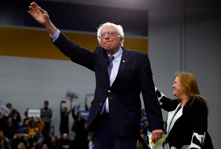 Democratic presidential candidate Bernie Sanders, accompanied by his wife, Jane O’Meara Sanders, arrives to speak to supporters at his primary night election rally Tuesday in Manchester, N.H.