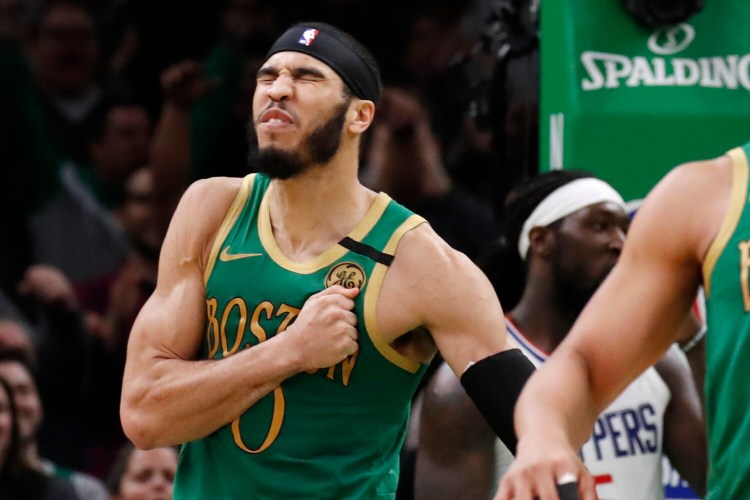 Boston Celtics forward Jayson Tatum celebrates after his basket in the second overtime of the Celtics' 141-133 win over the Los Angeles Clippers on Thursday in Boston.