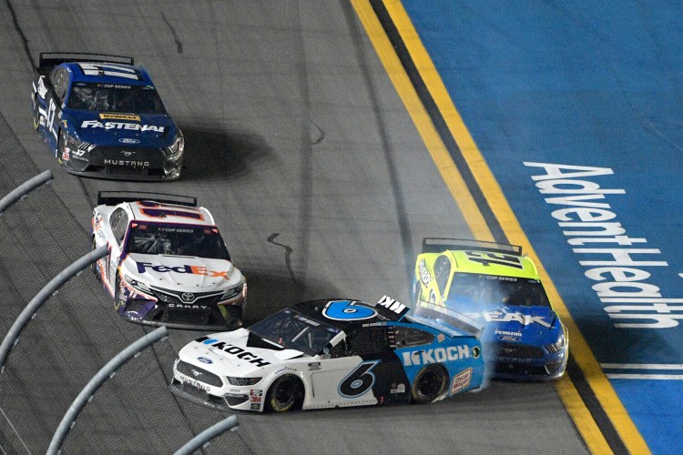 Ryan Newman gets turned into the wall by Ryan Blaney, 12,  as Denny Hamlin misses them along the front stretch on the final lap of the Daytona 500 on Monday. Hamlin won and Newman was in a horrific crash.
