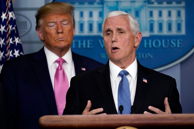 Vice President Pence speaks as President Trump listens during their news conference Wednesday at the White House about the threat of coronavirus in the U.S.