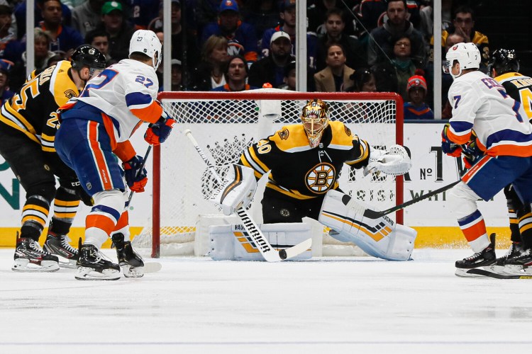 Boston goaltender Tuukka Rask makes one of his 25 saves against the New York Islanders on Saturday in Uniondale, NY. 
