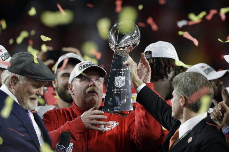 Kansas City Chiefs chairman Clark Hunt, right, hands the trophy to head coach Andy Reid after the Chiefs defeated the San Francisco 49ers 31-20 in the Super Bowl on Sunday night in Miami Gardens, Fla. 