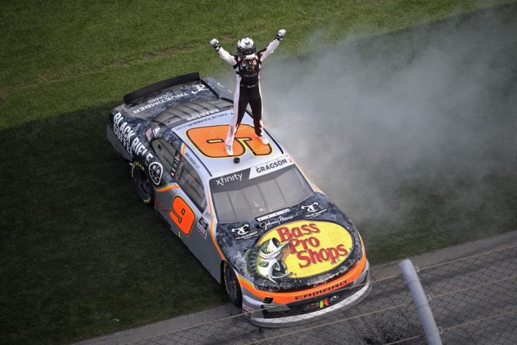 Noah Gragson celebrates on the roof of his car at the finish line after winning a NASCAR Xfinity Series at Daytona International Speedway, Saturday, in Daytona Beach, Fla. 