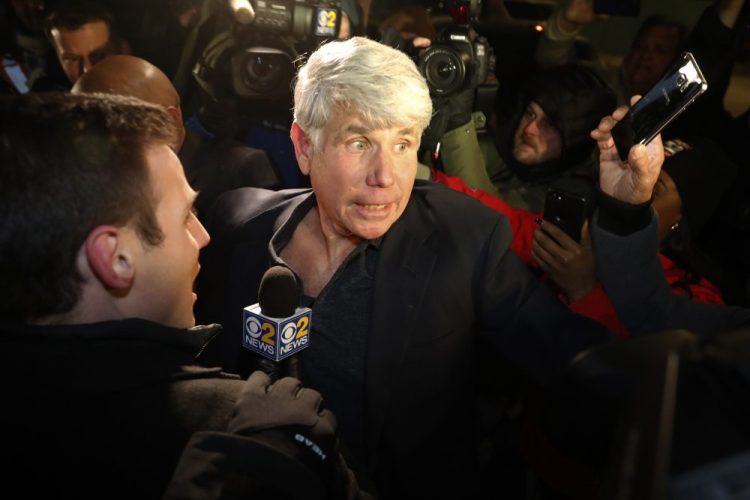 Former Illinois Gov. Rod Blagojevich tries to get into his house as he arrives home in Chicago on Wednesday after his release from Colorado prison late Tuesday. Blagojevich walked out of prison Tuesday after President Trump cut short the 14-year prison sentence handed to the former Illinois governor for wide-ranging political corruption. 