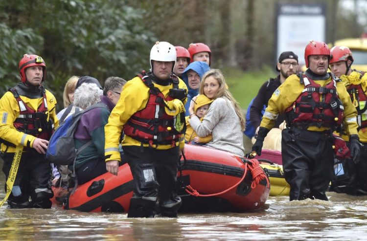Rescue operations continue as emergency services take residents to safety, in Nantgarw, Wales, on Sunday. Storm Dennis is roaring across Britain with high winds and heavy rains, prompting authorities to issue 350 flood warnings, including a “red warning" alert for life-threatening flooding in south Wales. 