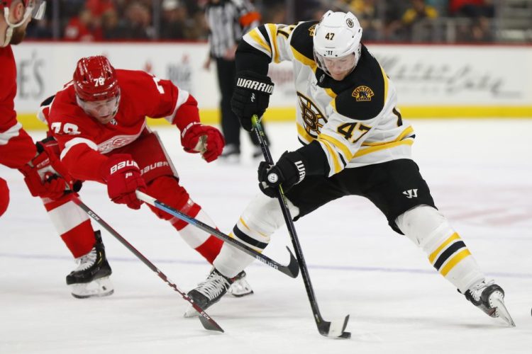Bruins defenseman Torey Krug protects the puck from Red Wings center Christoffer Ehn during the Bruins' 3-1 loss on Sunday in Detroit.