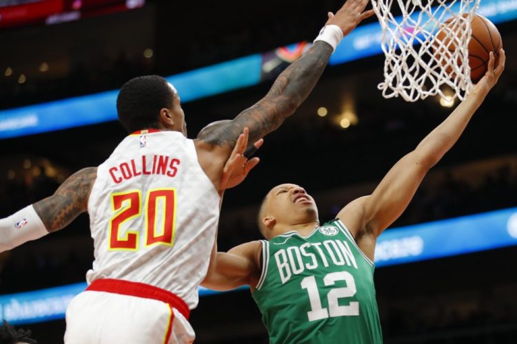 Celtics forward Grant Williams goes up for the shot as Atlanta forward John Collins defends during the Celtics' 123-115 win Monday in Atlanta.in the first half of an NBA basketball game on Monday, Feb. 3, 2020, in Atlanta. (AP Photo/Todd Kirkland)