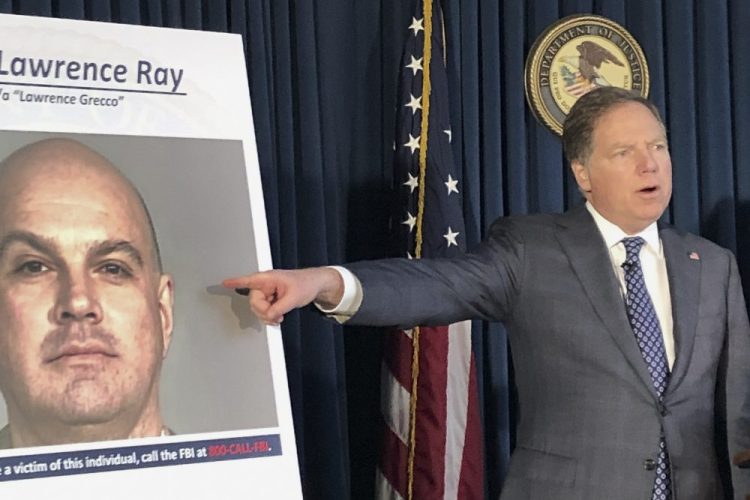 U.S. Attorney Geoffrey Berman points to a photo showing Lawrence Ray during a news conference, Tuesday in New York.  Ray, an ex-convict known for his role in a scandal involving former New York police commissioner Bernard Kerik, was charged Tuesday with federal extortion and sex trafficking charges involving a group of students at Sarah Lawrence College. (AP Photo/)