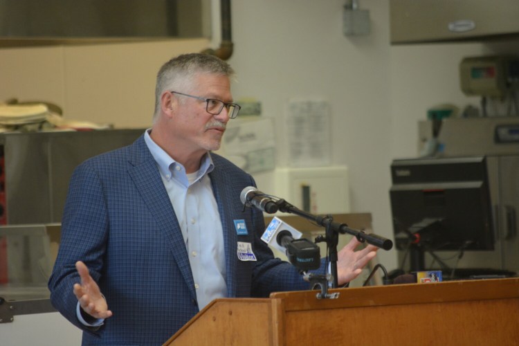 Oakhurst President John Bennett announces the dairy's $300,000 donation to launch an after-school meal program.