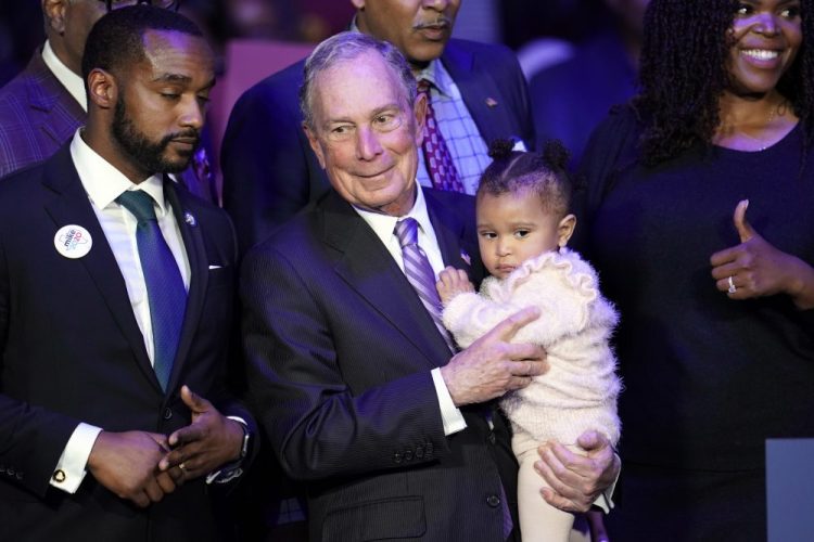 Democratic presidential candidate and former New York City Mayor Michael Bloomberg is joined on stage by supporters Thursday during his campaign launch of "Mike for Black America," at the Buffalo Soldiers National Museum in Houston.