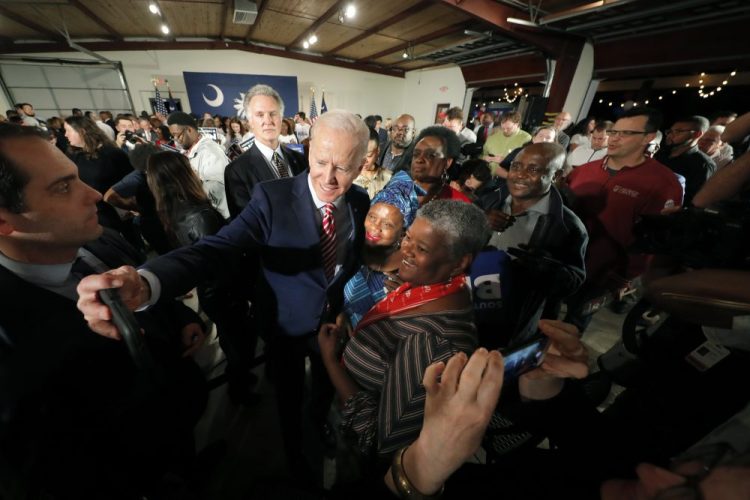 Democratic presidential candidate, former Vice President Joe Biden, takes photos with supporters after speaking Tuesday at a campaign event in Columbia, S.C.